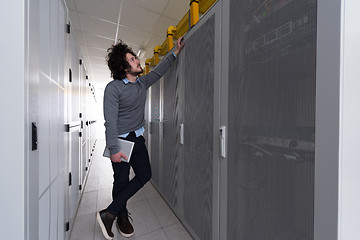 Image showing IT engineer working on a tablet computer in server room