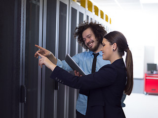 Image showing engineer showing working data center server room to female chief