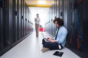 Image showing Team of young technicians working together on servers