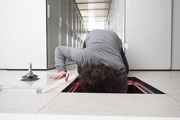 Image showing engineer connecting cables in server room