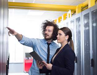 Image showing engineer showing working data center server room to female chief