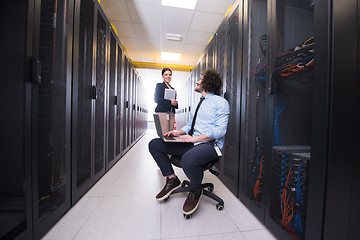 Image showing Team of young technicians working together on servers