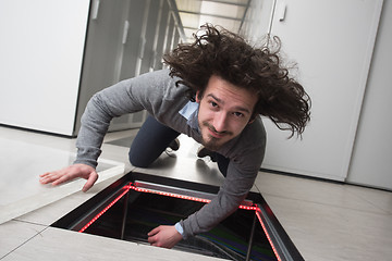 Image showing engineer connecting cables in server room