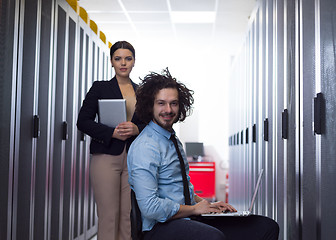 Image showing Team of young technicians working together on servers