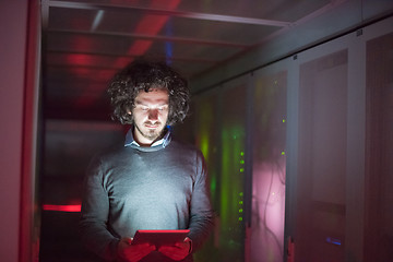 Image showing IT engineer working on a tablet computer in server room