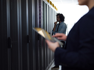 Image showing Female engineer working on a tablet computer in server room