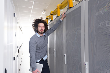 Image showing IT engineer working on a tablet computer in server room