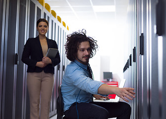 Image showing Team of young technicians working together on servers