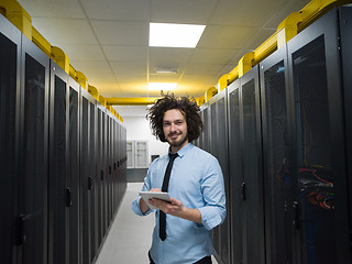 Image showing IT engineer working on a tablet computer in server room