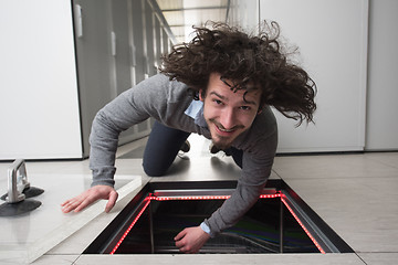 Image showing engineer connecting cables in server room