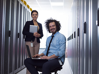 Image showing Team of young technicians working together on servers