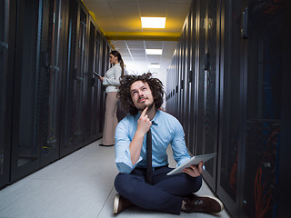 Image showing young technicians working together on servers