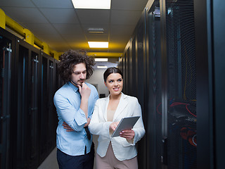 Image showing engineer showing working data center server room to female chief