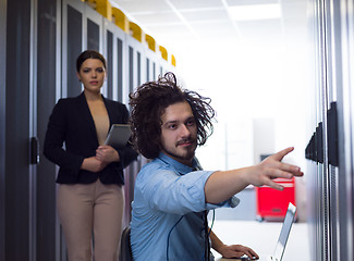 Image showing Team of young technicians working together on servers