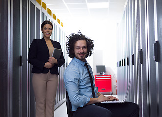 Image showing Team of young technicians working together on servers