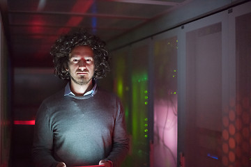 Image showing IT engineer working on a tablet computer in server room