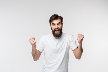 Image showing Winning success man happy ecstatic celebrating being a winner. Dynamic energetic image of male model