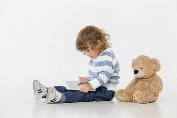 Image showing Portrait of happy joyful beautiful little boy sitting with laptop