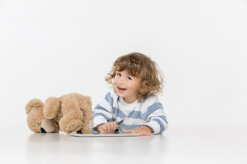 Image showing Portrait of happy joyful beautiful little boy sitting with laptop