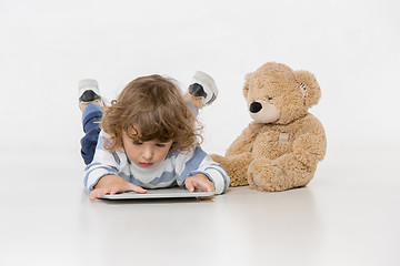 Image showing Portrait of happy joyful beautiful little boy sitting with laptop