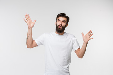 Image showing The young attractive man looking suprised isolated on white