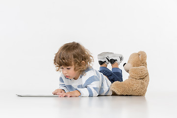 Image showing Portrait of happy joyful beautiful little boy sitting with laptop