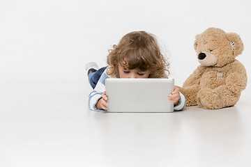 Image showing Portrait of happy joyful beautiful little boy sitting with laptop