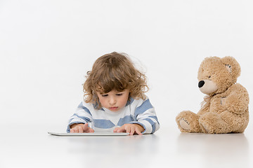 Image showing Portrait of happy joyful beautiful little boy sitting with laptop