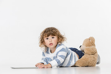 Image showing Portrait of happy joyful beautiful little boy sitting with laptop