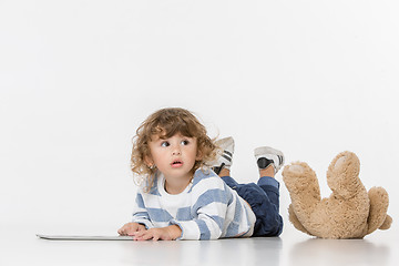 Image showing Portrait of happy joyful beautiful little boy sitting with laptop