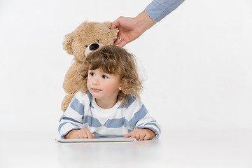 Image showing Portrait of happy joyful beautiful little boy sitting with laptop