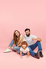 Image showing A happy family on pink background