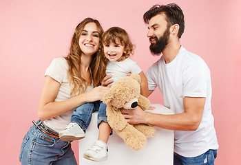 Image showing A happy family on pink background