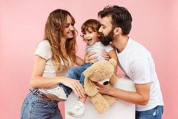 Image showing A happy family on pink background