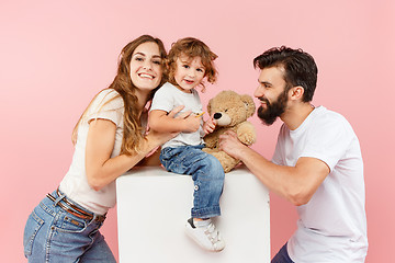 Image showing A happy family on pink background