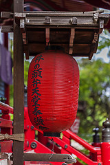 Image showing Traditional japanese red paper lantern near temple