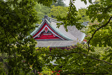 Image showing Red japanese temple among the trees in summer