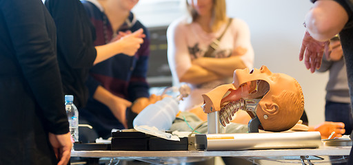 Image showing Medical doctor specialist expert displaying method of patient intubation on hands on medical education training and workshop. Participants learning new medical procedures and techniques.