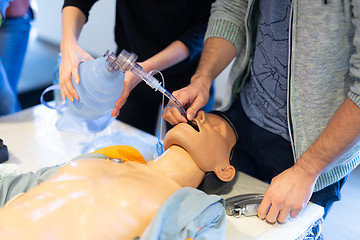 Image showing Medical doctor specialist expert displaying method of patient intubation on hands on medical education training and workshop. Participants learning new medical procedures and techniques.