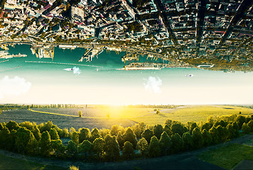 Image showing Natural landscape with unreal upside down sityscape.