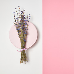 Image showing Duotone background with lavender bunch on a round board.