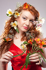 Image showing Portrait of beautiful woman with spring flowers 