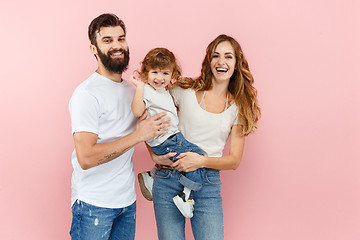 Image showing A happy family on pink background