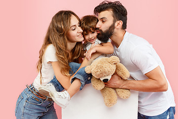 Image showing A happy family on pink background