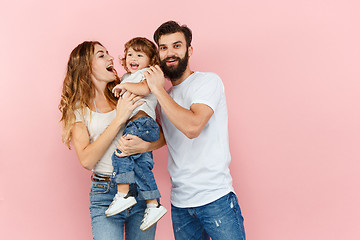 Image showing A happy family on pink background