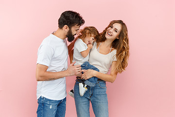 Image showing A happy family on pink background