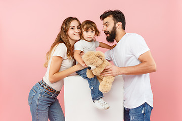 Image showing A happy family on pink background