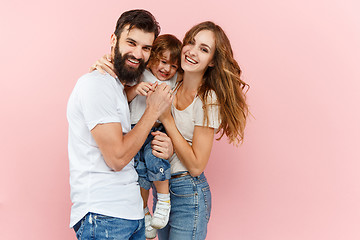 Image showing A happy family on pink background