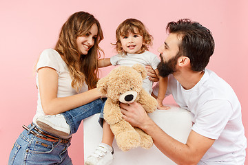 Image showing A happy family on pink background