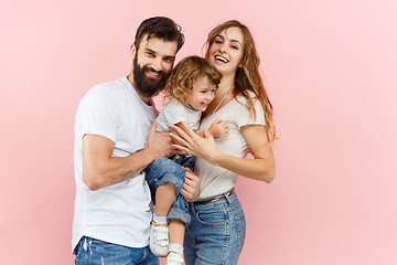 Image showing A happy family on pink background